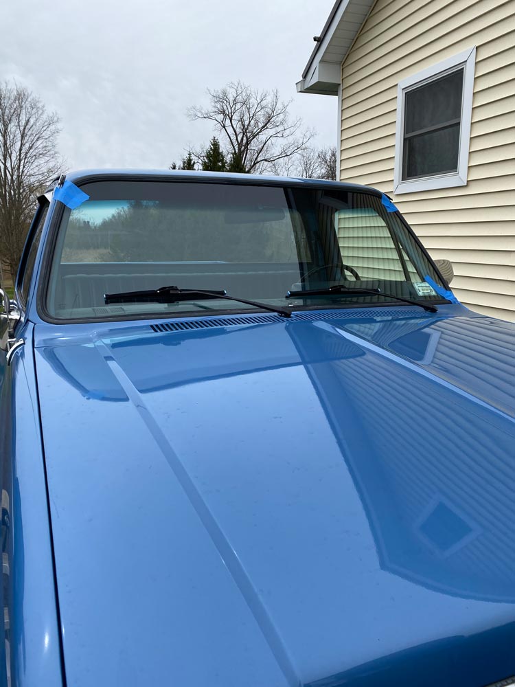 A new windshield on a blue car, installed by Tri County Glass & Doors Inc.